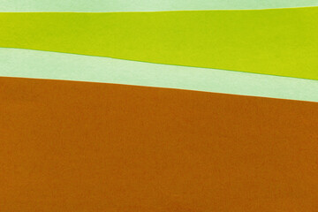 Fototapeta premium Green torn paper collage close-up. Texture made from various paper and cardboard parts. Damaged old paper background. Vintage blank wallpaper. Material design backdrop.
