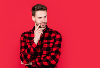 Fototapeta premium stylish male wear casual clothes. bearded man with bristle on unshaven face. fashion and beauty. barbershop concept. mens wear. young handsome guy in red checkered shirt. copy space