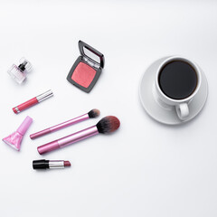 top view of feminine cosmetics and coffee on white background