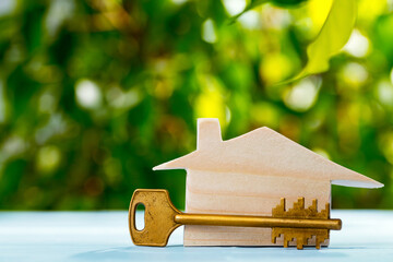 Wooden toy house and house keys close up