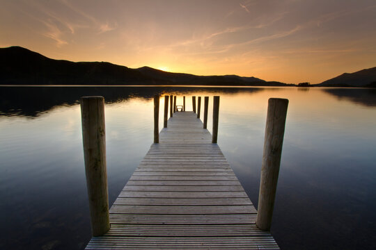 Wooden Pier Over Lake Against Sky During Sunset
