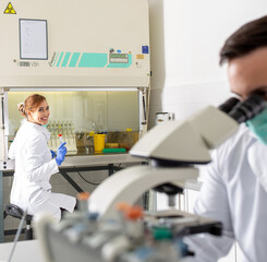 Biologists examining samples in laboratory