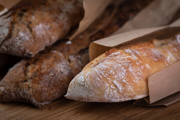 buckwheat and wheat baguettes on the table in paper packages