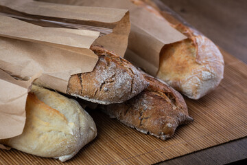 buckwheat and wheat baguettes on the table in paper packages
