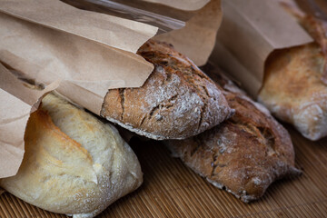 buckwheat and wheat baguettes on the table in paper packages