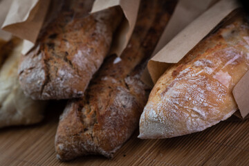 buckwheat and wheat baguettes on the table in paper packages
