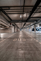 Interior of an underground bus parking with no vehicles. - obrazy, fototapety, plakaty