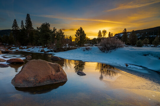Beautiful sunrise image of a wintery creek with snow.