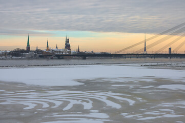 Fototapeta na wymiar riga. panorama of the city in winter, with a frozen river in the foreground