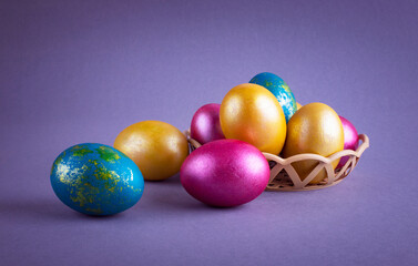 Bright colored eggs on a gray background. Easter theme, holiday. Happy easter card with copy space for text in minimalist easter style. Color of the year. Grey.