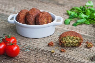 Fresh chickpeas falafel with tomatoes and pasley.