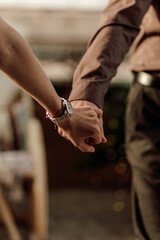 Hands of romantic couple walking happy together indoor in apartment. Close up of holding hands together