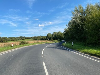 Looking along, Boroughbridge Road, with fields, trees, and a blue sky in, Scriven, Harrogate, UK
