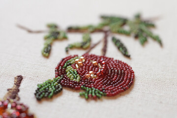 Fototapeta na wymiar Couture embroidery of pomegranate. Still life with fruits