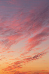 Dramatic soft sunrise, sunset, pink violet orange sky with bright clouds in sunlight background texture