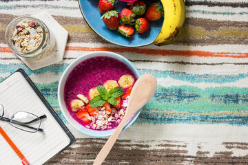 Dragon fruit smoothie bowl lay flat with strawberries and banana