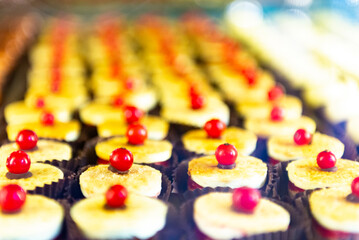 Small cakes in large quantities. Sweets with red currants