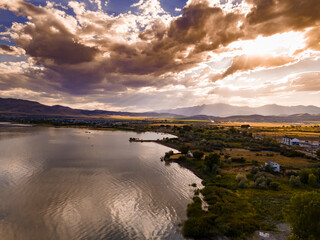 Aerial view of a lake with dramatic clouds overhead