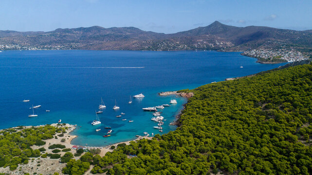 Green peninsula with yachts and boats near it in Greece