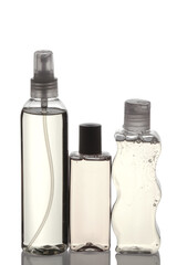Three Plastic Hand Sanitizer Bottles with reflection isolated on white.