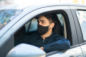 Young man driving his car.