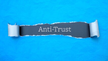 Anti-Trust. Blue torn paper banner with text label. Word in gray hole.