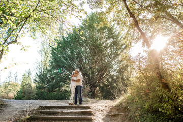 Senior couple in love and very happy enjoying a walk in the field at sunset