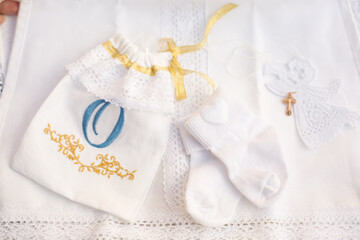 Obraz na płótnie Canvas Christening accessories: little white socks, a box with golden cross and pouch for cropped hairs