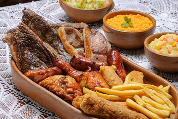 Mixed meal with pork, picanha, sausage, fried chicken and breaded banana. Accompanied by chips, flour and vinaigrette. Traditional dish of Brazilian cuisine.