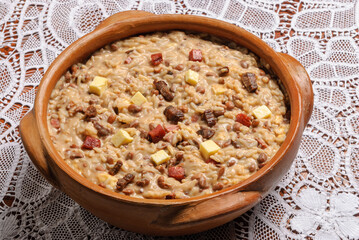 Rubacao, a traditional dish from the northeast of Brazil, made with beans, rice, sun-dried meat and rennet cheese, served in a clay bowl. Brazilian cuisine.