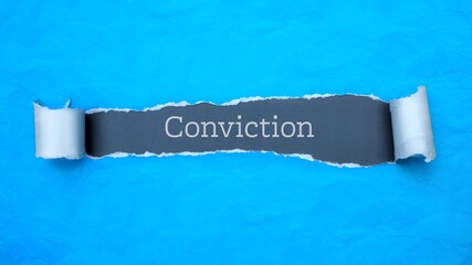 Conviction. Blue torn paper banner with text label. Word in gray hole.