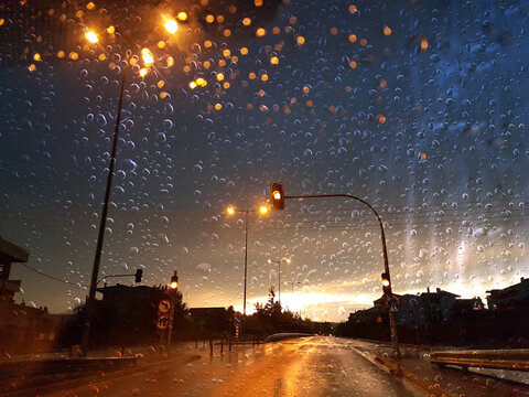 rain  drops on the car glass while driving in the rain night foggy weather in ioannina greece