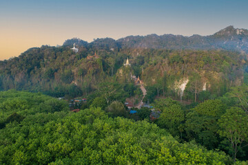 Fototapeta na wymiar Trees in the forest, aerial view above, a pagoda perched on a mountain,thamma park Ban khao na nai,Surat thani Thailand
