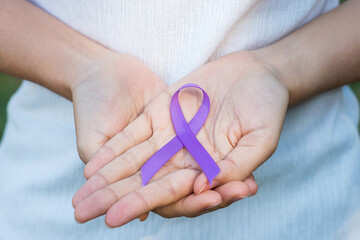 Pancreatic Cancer, world Alzheimer, epilepsy, lupus and domestic violence day Awareness month, Woman holding purple Ribbon for supporting people living. Healthcare and World cancer day concept