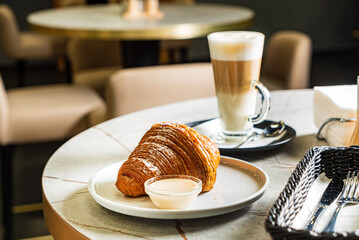 croissant and cappuccino in the cafe