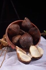 pile of fresh zalacca fruit on a black background
