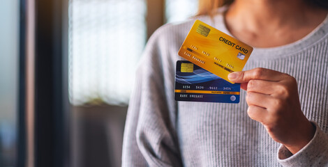 Closeup image of a woman holding and showing credit cards
