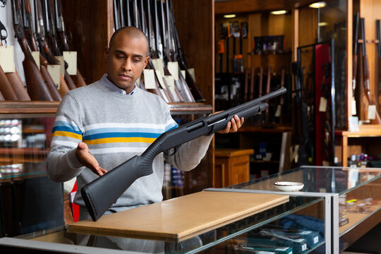 Seller demonstrates a combat winchester in the gun store