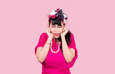 Attractive energetic Asian woman happy isolated on pink studio background.Retro vintage 50's style Emotion face expressi