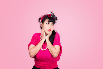 Obraz na płótnie Canvas Attractive energetic Asian woman happy isolated on pink studio background.Retro vintage 50's style Emotion face expressi