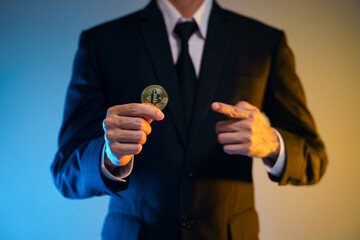 Close up shot of Businessman holding golden coin.
