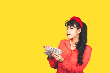 Woman black head Asian young women,Happy using the US dollar.,isolated on yellow background. Retro vintage 50's style Emotion face expression.