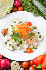 Light and delicate salad on a white plate. Restaurant serving concept. Close-up.