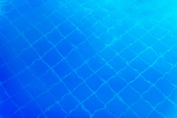 Fototapeta na wymiar Blue swimming pool water with small square tile texture