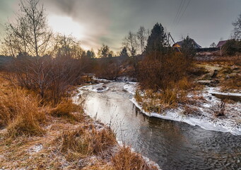 Fast river with ice in late autumn