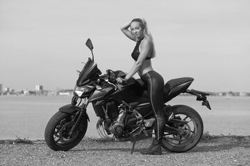 Plakat young woman with a sports motorcycle