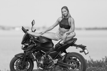 Fototapeta na wymiar young woman with a sports motorcycle
