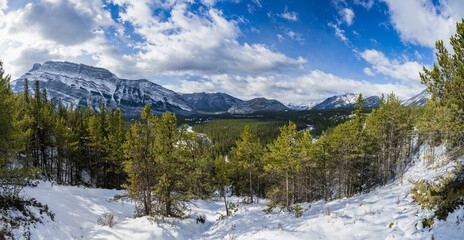 Banff National Park beautiful mountain landscape. Panorama view Mount Rundle valley forest and Bow River in snowy autumn sunny day. Hoodoos Viewpoint, Canadian Rockies.