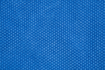 The texture of a cotton kimono for judo classes. Blue fabric close-up. The view from the top.