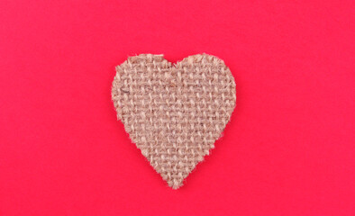 Wicker wooden heart on a pink background